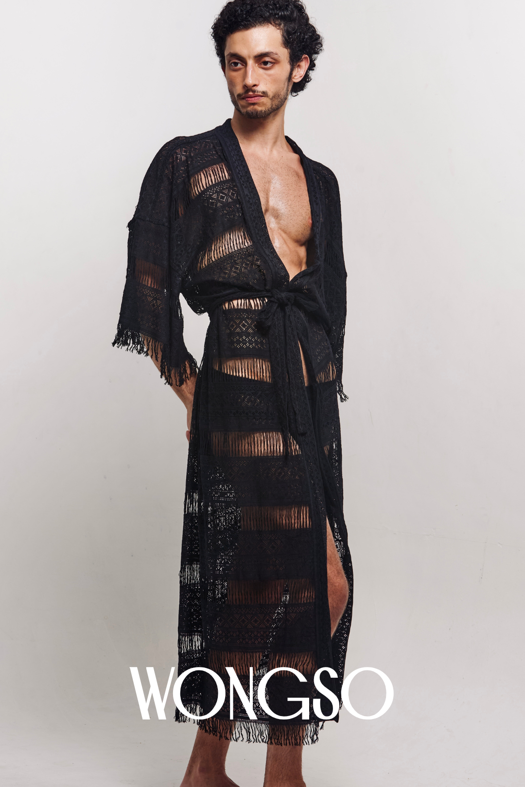 Model lounging wearing WONGSO fringe robe for men