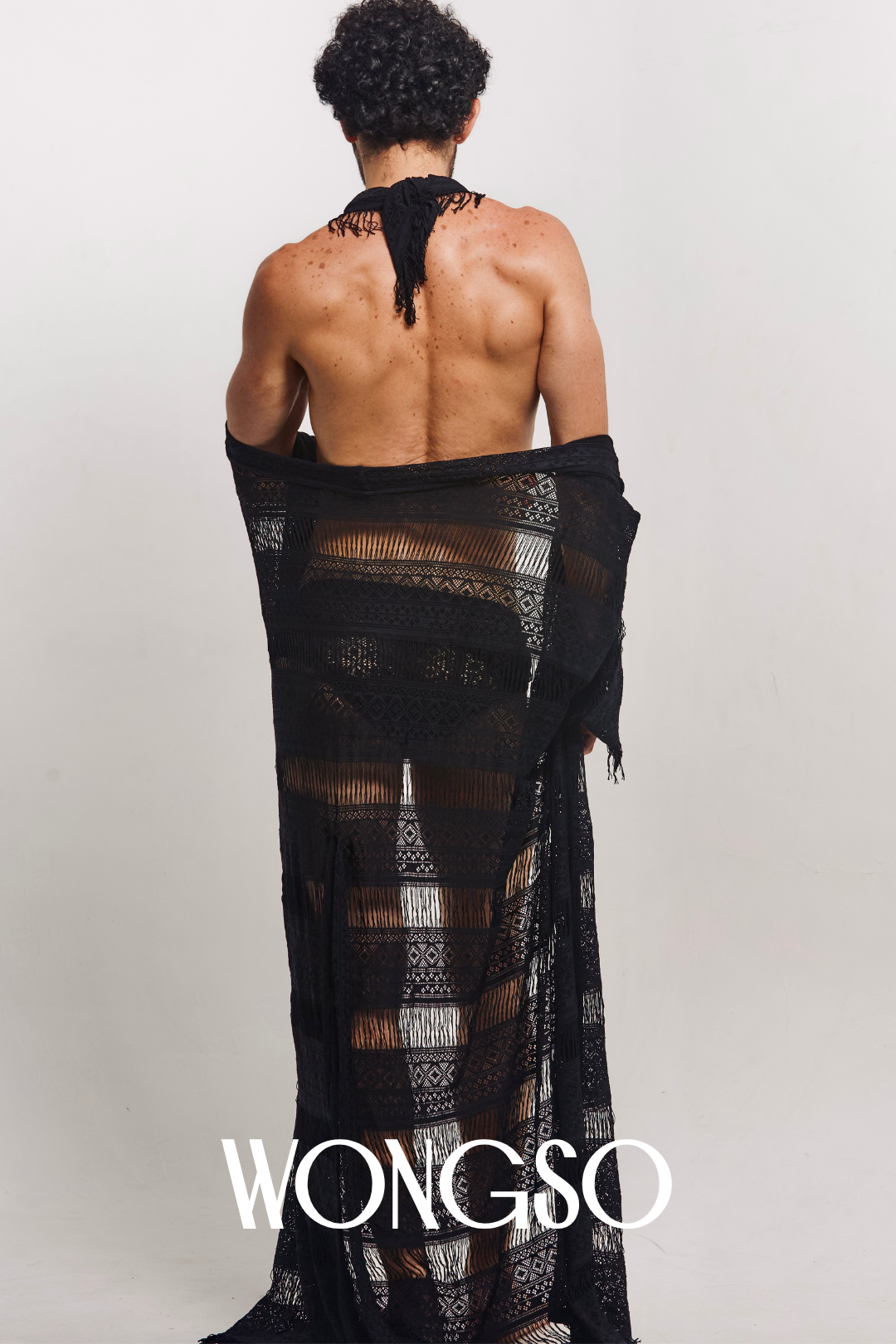 Back view of model walking in sheer lace robe for men