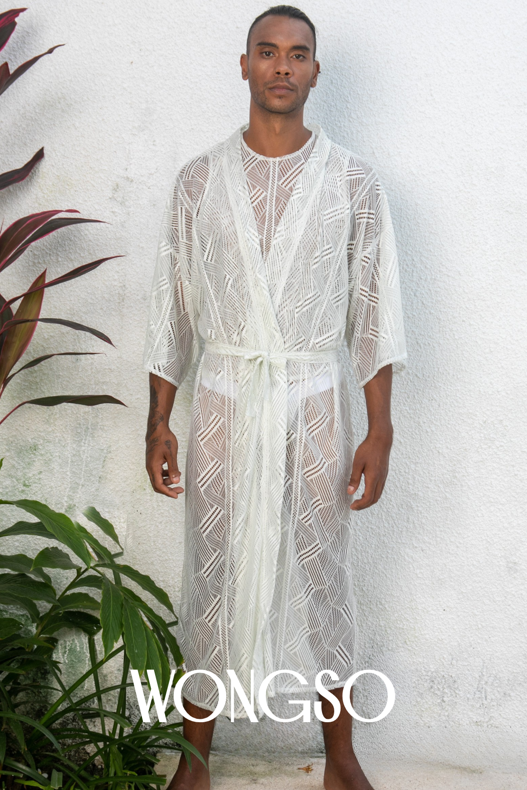 Close-up of textured lace on black geometric kimono – statement resortwear