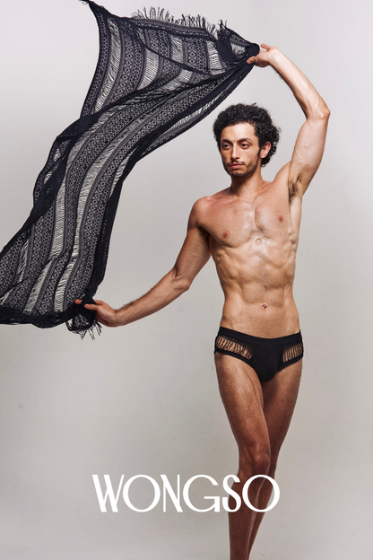 Men's lace sarong styled with black fringe briefs