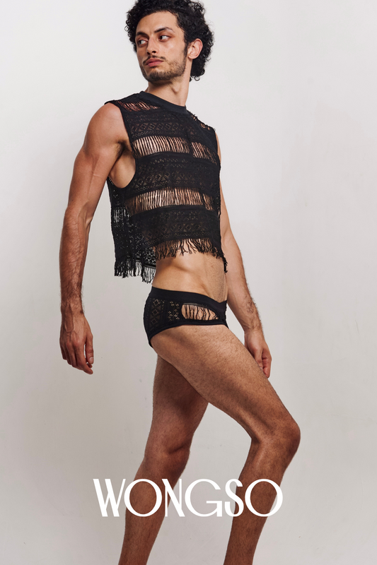 Man in fringe black mesh tank top posing